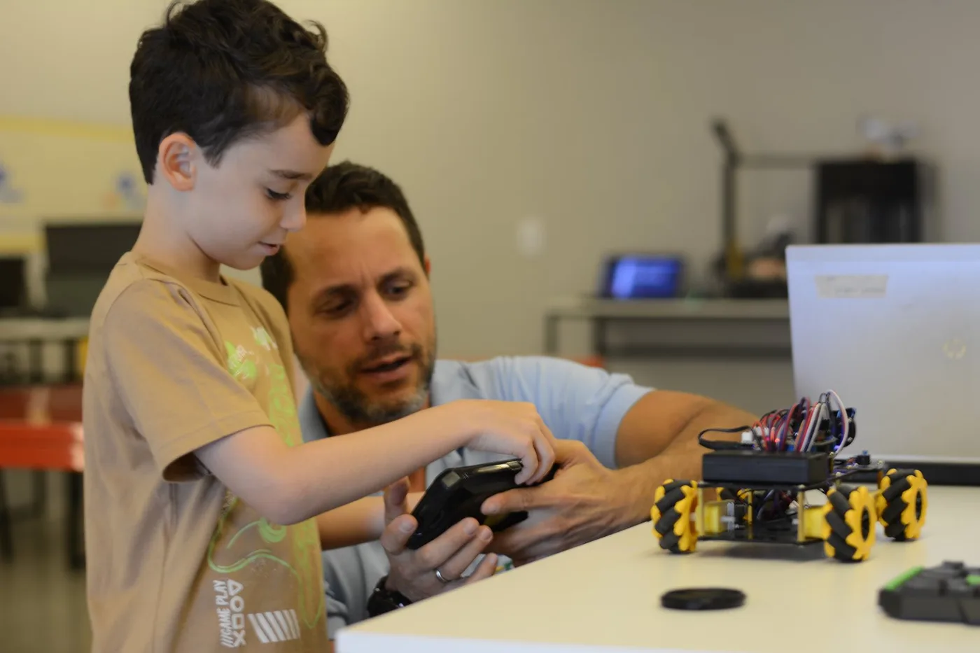 Aluno recebendo orientação durante uma atividade de robótica na Microbot